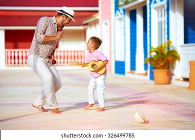 happy family playing music and dancing on caribbean street