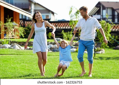 Happy family playing on a lawn