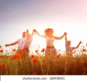Happy Family Playing On The Poppy Meadow