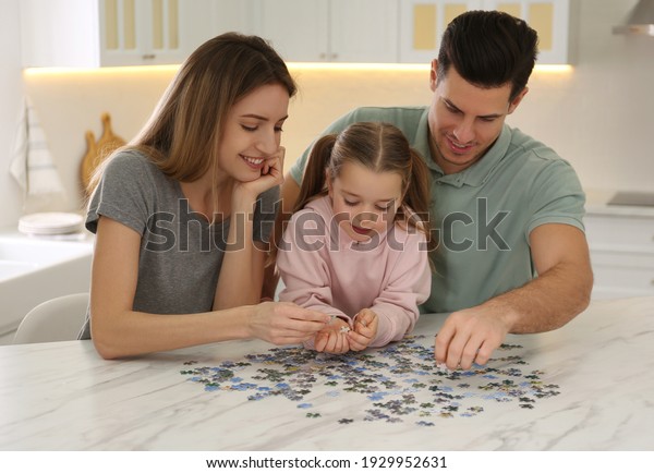 Happy family playing\
with puzzles at home