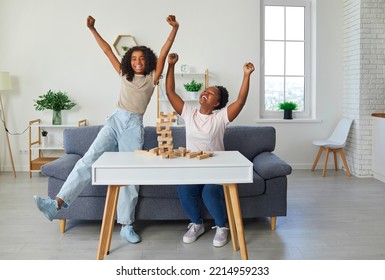 Happy Family Playing Table Games At Home. Cheerful African American Mother And Child Playing Games And Having Fun Together. Joyful, Excited Little Girl Celebrating Her Victory In Board Game