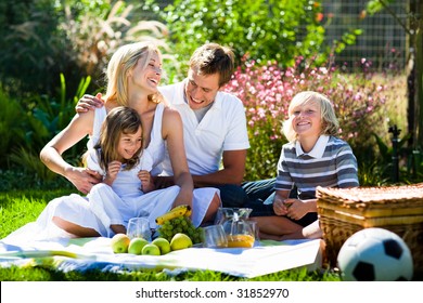 Happy family playing together in a picnic outdoors - Powered by Shutterstock