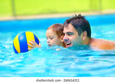 Happy Family Playing In Water Polo In The Pool