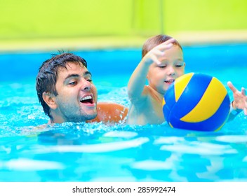 Happy Family Playing In Water Polo In The Pool