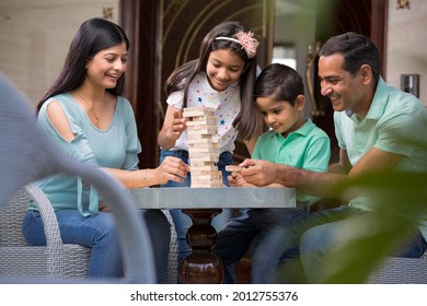 Happy Family Playing With The Wooden Blocks At Home