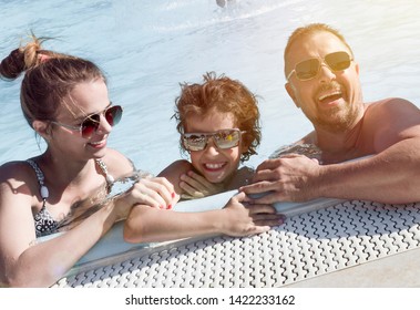 Happy Family In The Pool, Having Fun In The Water, Mother With Three Kids Enjoying Aqua Park, Beach Resort, Summer Holidays, Vacation Concep