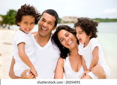 Happy Family Portrait At The Beach Smiling