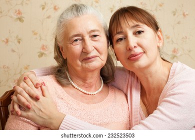 Happy Family. Portrait Of Elderly Woman And Adult Daughter Happily Looking At Camera. Senior  Woman With Their Caregiver At Home.