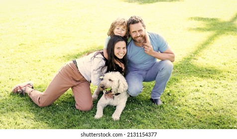 Happy Family Portrait Of Mom Dad And Kid Boy Playing With Pet In Park On Green Grass, Togetherness