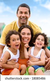 Happy Family Portrait Outdoors During A Holiday - Togetherness Concept