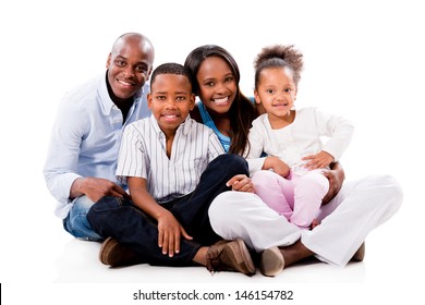 Happy family portrait sitting on the floor - isolated over white 