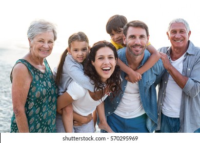 Happy family posing at the beach on a sunny day
