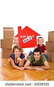 Happy Family Posing With The House Sold Sign On The Floor Of Their New Home - Isolated