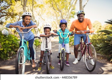 Happy Family Posing Together At Park