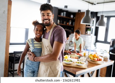 Happy family preparing healthy food in kitchen together - Powered by Shutterstock