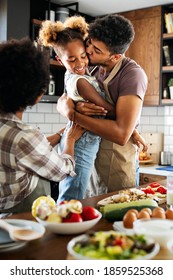 Happy family preparing healthy food in kitchen together