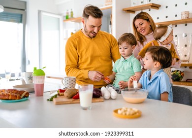 Happy family preparing healthy food together in kitchen