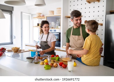 Happy family preparing healthy food together in kitchen - Powered by Shutterstock