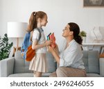 Happy family preparing for school. Little girl with mother.