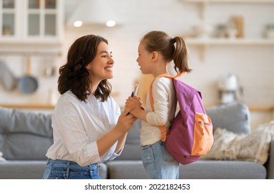 Happy family preparing for school. Little girl with mother. - Powered by Shutterstock