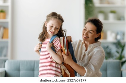 Happy family preparing for school. Little girl with mother.