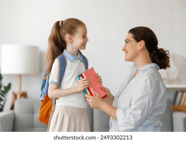 Happy family preparing for school. Little girl with mother. - Powered by Shutterstock