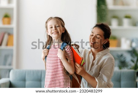 Happy family preparing for school. Little girl with mother. Foto stock © 