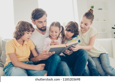Happy family read interesting book wear in denim, jeans outfit wear sit on couch in light bright apartment living room - Shutterstock ID 1185203698