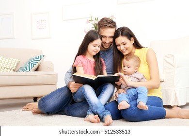 Happy Family Reading Book At Home