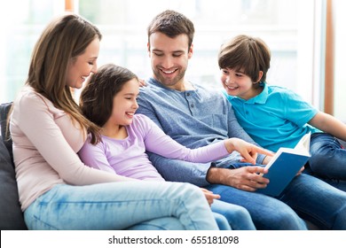 Happy Family Reading Book Together
