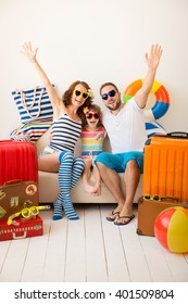 Happy Family Ready For A Summer Vacation. Father, Mother And Child Having Fun At Home