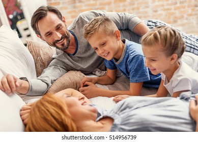 Happy family relaxing at home - Powered by Shutterstock