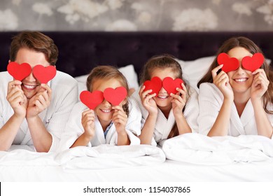 Happy Family Relaxing In Hotel Room