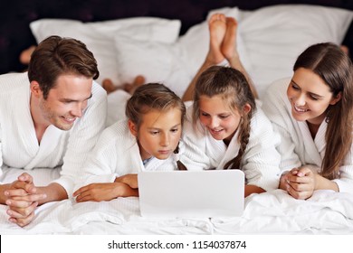 Happy Family Relaxing In Hotel Room