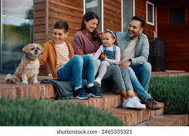 Happy family relaxing with their dog on staircase in the backyard. - Powered by Shutterstock