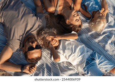 Happy Family Relaxing Together on Beach Blanket in the Sun

 - Powered by Shutterstock