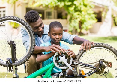 Happy Family Repairing A Bike