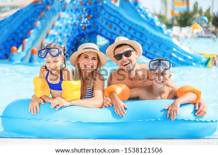 Happy family resting in aqua park