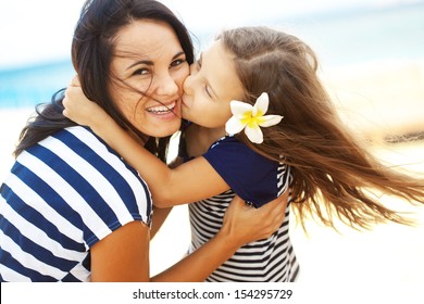 Happy Family Resting At Beach In Summer