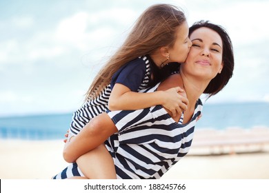 Happy Family Resting At Beach In Summer