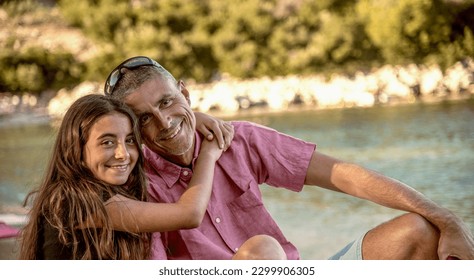 Happy family resting at beach in summer. Father and daughter together on the beach chair smiling. - Powered by Shutterstock