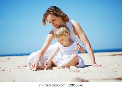 Happy family resting at beach in summer - Powered by Shutterstock