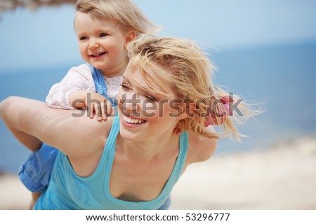 Happy family resting at beach in summer