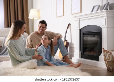 Happy Family Resting Near Fireplace At Home