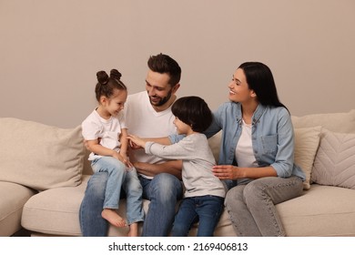 Happy family resting on sofa in living room - Shutterstock ID 2169406813