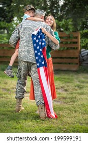 Happy Family Reunited, Father In Military Uniform Returns Home . Us Happy Family Portrait. Focus On Man