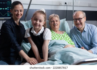 Happy Family Reunited In Grandmother Recovery Room After Successful Medical Intervention At Geriatric Hospital. Joyful Gathering Of Elderly Woman Relatives Before Surgery In Clinic.