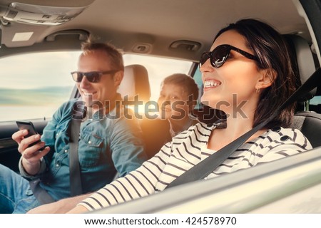 Happy family riding in a car
