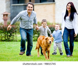 Happy Family Running At The Backyard And Having Fun