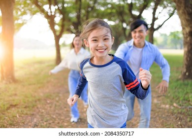 Happy Family  running and playing together in the park - Powered by Shutterstock